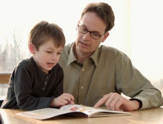 child reading with father